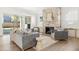 Cozy living room with stone fireplace, gray seating, and sliding glass doors to the backyard at 48 25Th St, Atlanta, GA 30309