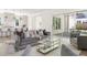 Open living room with gray sofas, glass coffee table, and sliding doors to outdoor patio at 48 25Th St, Atlanta, GA 30309