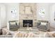 Inviting living room showcasing stone fireplace, two gray chairs, and a glass coffee table at 48 25Th St, Atlanta, GA 30309