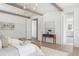 Spacious main bedroom with beamed ceilings, hardwood flooring, and multiple doors leading to other areas at 48 25Th St, Atlanta, GA 30309