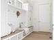Well-organized mudroom with bench seating, storage cabinets and hooks for coats at 48 25Th St, Atlanta, GA 30309