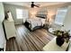 Well-lit bedroom with wood-look flooring, ceiling fan, and neutral decor at 6060 Carriage Dr, Cumming, GA 30028