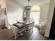 Charming dining room featuring a chandelier, a large window, and seating for six at 6060 Carriage Dr, Cumming, GA 30028
