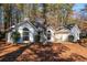 Charming single-story home featuring a neatly maintained lawn and a welcoming front porch swing at 6060 Carriage Dr, Cumming, GA 30028