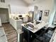Spacious kitchen featuring white cabinets, stainless steel appliances, and a center island with breakfast bar seating at 6060 Carriage Dr, Cumming, GA 30028