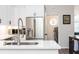 Bright modern kitchen featuring stainless steel appliances, white cabinets, and sleek countertops at 6060 Carriage Dr, Cumming, GA 30028