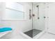 Walk-in shower with glass door, black fixtures, and white tiling at 6060 Carriage Dr, Cumming, GA 30028