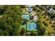 Aerial view of community amenities including a pool, tennis courts, and mature trees at 1050 Dunedin Trl, Woodstock, GA 30188