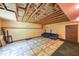 Partially unfinished basement with dark leather sofa and open ceiling at 1050 Dunedin Trl, Woodstock, GA 30188