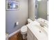 Powder bathroom features a white single sink vanity, and a framed picture at 1050 Dunedin Trl, Woodstock, GA 30188