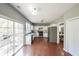Well-lit kitchen featuring white cabinets, stainless steel appliances, and hardwood flooring at 1050 Dunedin Trl, Woodstock, GA 30188