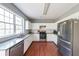 Bright kitchen featuring stainless steel appliances, granite countertops, and hardwood floors at 1050 Dunedin Trl, Woodstock, GA 30188