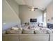 Living room with a fireplace, large sectional, and natural light from the oversized windows at 1050 Dunedin Trl, Woodstock, GA 30188