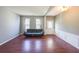 Bright living room featuring hardwood floors, neutral walls, and a walk-out door to the backyard at 1050 Dunedin Trl, Woodstock, GA 30188