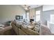Bright living room offers a cozy fireplace, vaulted ceilings and a large comfortable sectional couch at 1050 Dunedin Trl, Woodstock, GA 30188