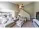 Spacious living room featuring vaulted ceilings, a ceiling fan, and an open floor plan to the kitchen at 1050 Dunedin Trl, Woodstock, GA 30188