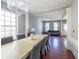Open-concept living and dining areas featuring hardwood floors, large windows, and stylish decor at 1050 Dunedin Trl, Woodstock, GA 30188