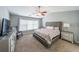 Comfortable main bedroom boasts a large window, ceiling fan, and ensuite bathroom access at 1050 Dunedin Trl, Woodstock, GA 30188