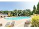Community pool with lounge chairs, lush landscaping, and a nearby clubhouse at 1050 Dunedin Trl, Woodstock, GA 30188