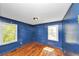 Bedroom with blue walls, hardwood floors, and double windows for natural light at 2194 Ivydale St, Atlanta, GA 30344