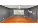 Bedroom featuring wood floors, neutral walls, ceiling fan, and a large window at 2194 Ivydale St, Atlanta, GA 30344