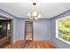 Dining room featuring wood floors, gray paneled walls, and chandelier lighting at 2194 Ivydale St, Atlanta, GA 30344