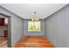 Charming dining area with hardwood floors, paneled walls, and a view to other rooms at 2194 Ivydale St, Atlanta, GA 30344
