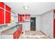 Kitchen features granite counters, double bowl sink, red cabinetry, and access to another room at 2194 Ivydale St, Atlanta, GA 30344