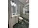 Well-lit bathroom featuring modern vanity, sleek fixtures, and a glass-enclosed shower with black accents at 4321 Austell Powder Springs Sw Rd, Powder Springs, GA 30127