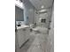 Modern bathroom featuring marble floors, sleek fixtures, and a bathtub with stylish tiling accents at 4321 Austell Powder Springs Sw Rd, Powder Springs, GA 30127