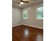 Bright bedroom featuring hardwood floors and natural light from two windows at 4321 Austell Powder Springs Sw Rd, Powder Springs, GA 30127