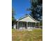 Exterior view of home showcasing its inviting front porch and manicured lawn at 4321 Austell Powder Springs Sw Rd, Powder Springs, GA 30127
