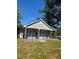 Inviting single-story home featuring a covered porch with stone accents and black iron railings at 4321 Austell Powder Springs Sw Rd, Powder Springs, GA 30127