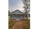 Charming home featuring a welcoming front porch with stone supports and wrought iron railing at 4321 Austell Powder Springs Sw Rd, Powder Springs, GA 30127
