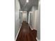 Hallway with hardwood floors, neutral paint and modern lighting at 4321 Austell Powder Springs Sw Rd, Powder Springs, GA 30127