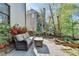 Relaxing back patio with outdoor seating, beautiful landscaping, and a charming view at 6770 Ulster Ct, Alpharetta, GA 30005