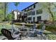 Large backyard featuring a fire pit, a relaxing patio and lush surroundings at 6770 Ulster Ct, Alpharetta, GA 30005