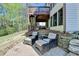 Serene backyard featuring a patio with seating and stairs leading to the deck at 6770 Ulster Ct, Alpharetta, GA 30005