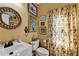 Cozy bathroom with vanity, floral wallpaper, and natural lighting at 6770 Ulster Ct, Alpharetta, GA 30005