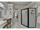 This bathroom offers a vanity with mirrors, a glass enclosed shower and tiled floors at 6770 Ulster Ct, Alpharetta, GA 30005