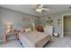 This bedroom features a ceiling fan, neutral colors, and a comfortable bed at 6770 Ulster Ct, Alpharetta, GA 30005