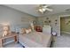 Comfortable bedroom featuring neutral colors, a ceiling fan, and stylish decor for a cozy and inviting atmosphere at 6770 Ulster Ct, Alpharetta, GA 30005