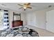 Spacious bedroom with patterned bedding, a ceiling fan, dresser, closet, and ample natural light for a comfortable space at 6770 Ulster Ct, Alpharetta, GA 30005