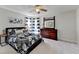 Comfortable bedroom features a patterned comforter, ceiling fan, dresser, and stylish decor, creating a peaceful retreat at 6770 Ulster Ct, Alpharetta, GA 30005