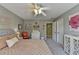 Bright bedroom with neutral wall color, with an area rug and ceiling fan for a cozy and inviting atmosphere at 6770 Ulster Ct, Alpharetta, GA 30005
