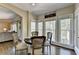Eat-in kitchen nook with a dark wood table set for four with bright natural light at 6770 Ulster Ct, Alpharetta, GA 30005