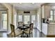Eat-in kitchen nook with a dark wood table set for four and bright natural light at 6770 Ulster Ct, Alpharetta, GA 30005