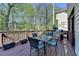 Outdoor deck featuring a dining table, grill, and scenic views of the surrounding greenery at 6770 Ulster Ct, Alpharetta, GA 30005