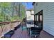 Outdoor deck featuring a dining table, grill, and scenic views of the surrounding greenery at 6770 Ulster Ct, Alpharetta, GA 30005
