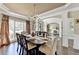 Spacious dining area with hardwood floors, decorative lighting, and open layout at 6770 Ulster Ct, Alpharetta, GA 30005